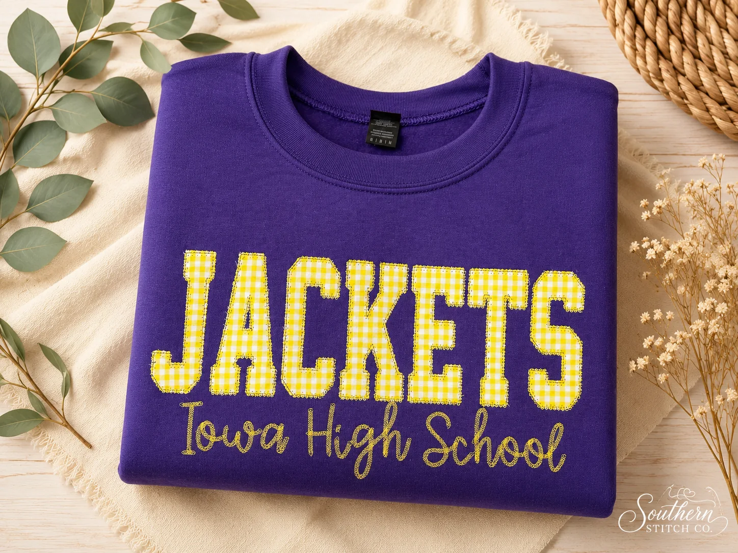 Purple Jackets sweatshirt with yellow gingham appliqué.