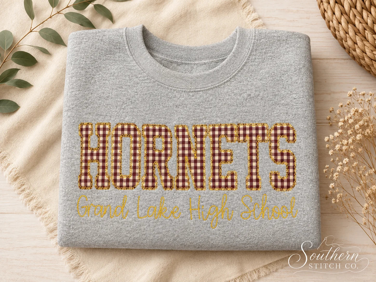 Gray Grand Lake High School Hornets sweatshirt with maroon gingham and gold lettering.