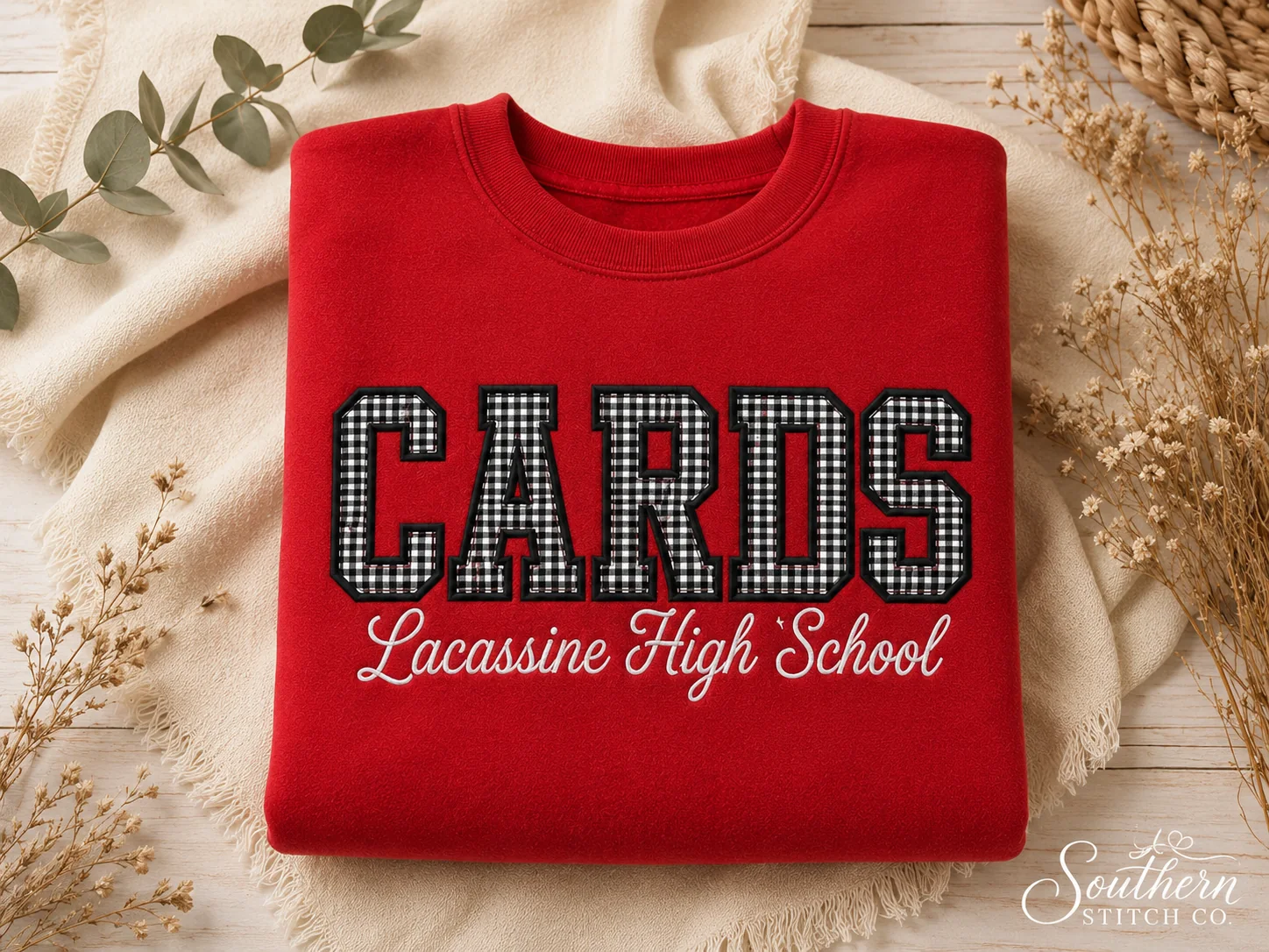 Red Lacassine High School Cards sweatshirt mockup with black gingham appliqué.